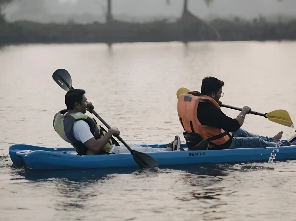 Guided kayaking through Kochi backwaters with beginners and families exploring scenic mangrove waterways